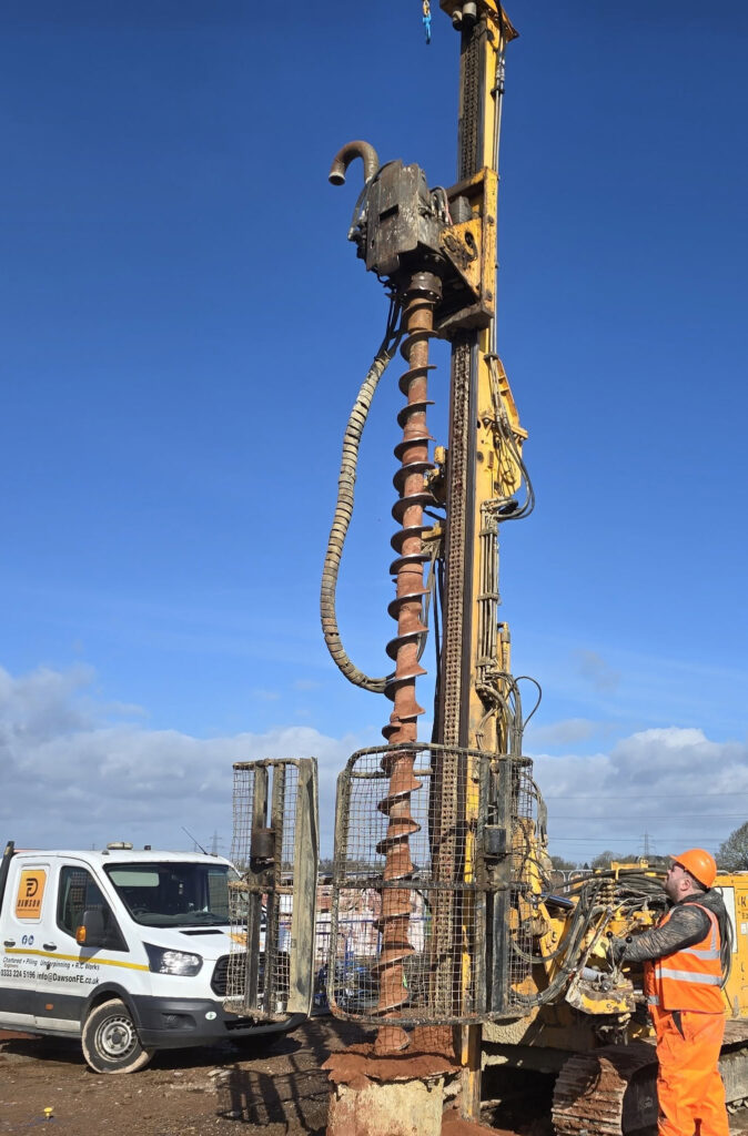 Dawson FE Klemm 709 piling rig installing mini piles on a construction site, with an operator working beside the rig.